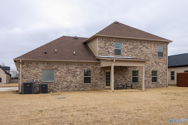 rear view of property with central AC