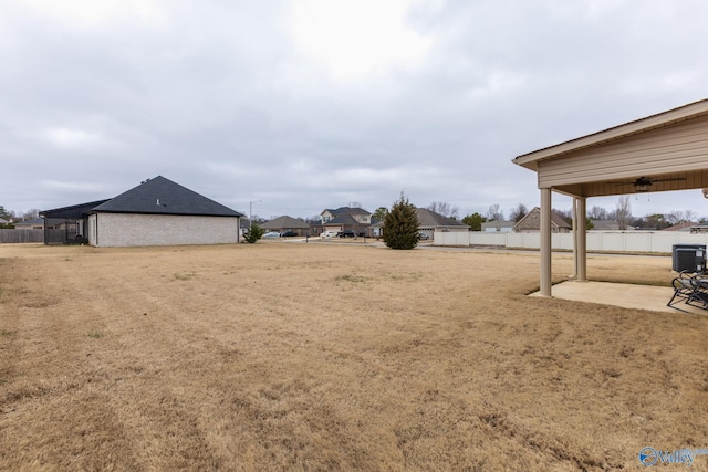 view of yard featuring central AC unit and a patio