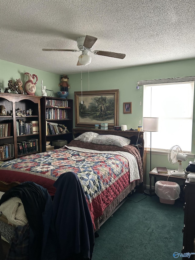 carpeted bedroom with ceiling fan and a textured ceiling