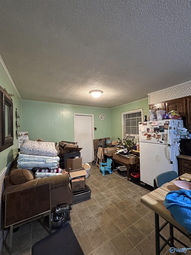 living room featuring crown molding, tile patterned flooring, and a textured ceiling