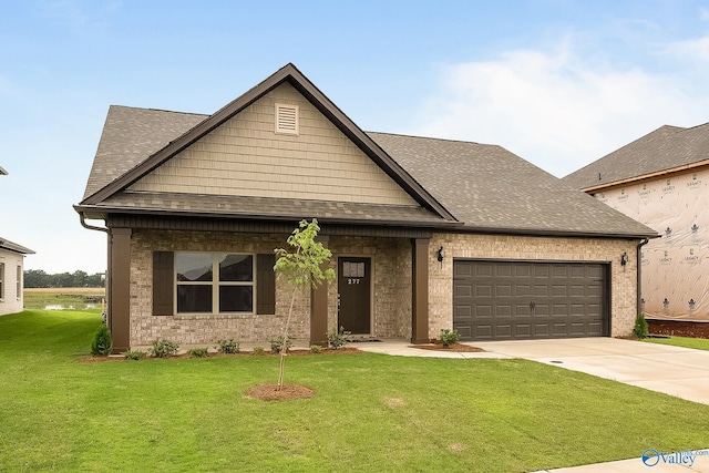 view of front of house featuring a garage and a front lawn