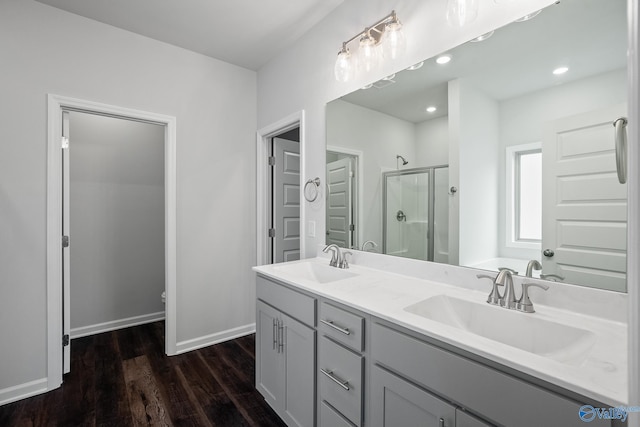 bathroom featuring vanity, a shower with door, and hardwood / wood-style floors