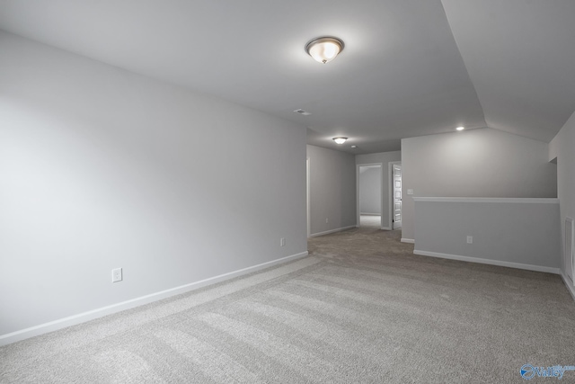 interior space with lofted ceiling and light carpet