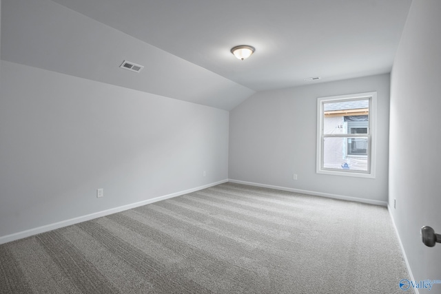 bonus room featuring light colored carpet and lofted ceiling