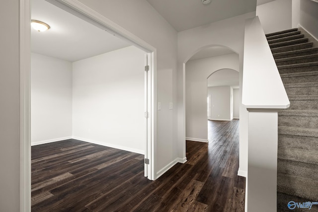 hallway with dark hardwood / wood-style floors