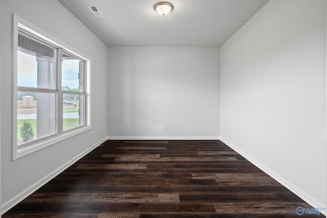 spare room with dark hardwood / wood-style floors