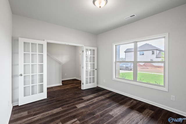 empty room featuring dark wood-type flooring and french doors