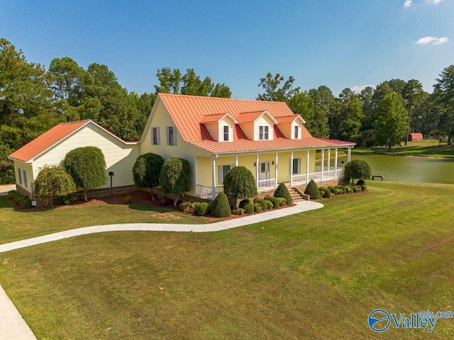 view of front of property featuring covered porch, a front lawn, and a water view