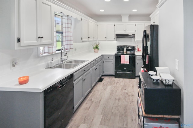 kitchen with black appliances, sink, gray cabinets, light wood-type flooring, and white cabinets