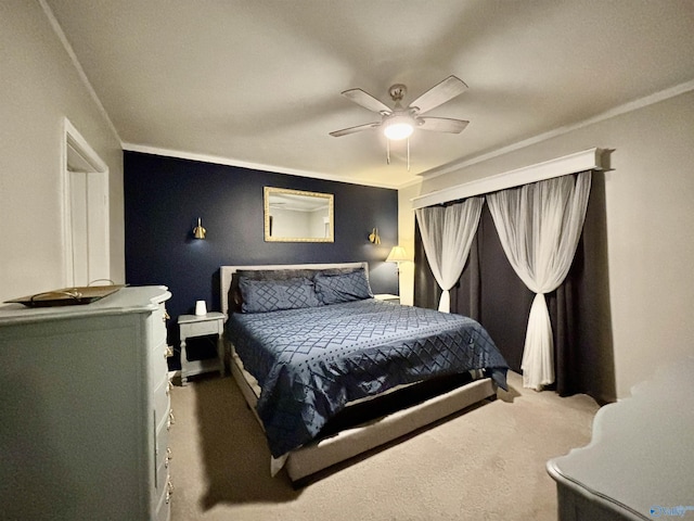 carpeted bedroom featuring ceiling fan and ornamental molding