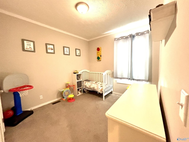 bedroom featuring baseboards, visible vents, carpet, a textured ceiling, and a nursery area