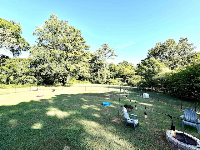 view of yard with a fire pit and fence