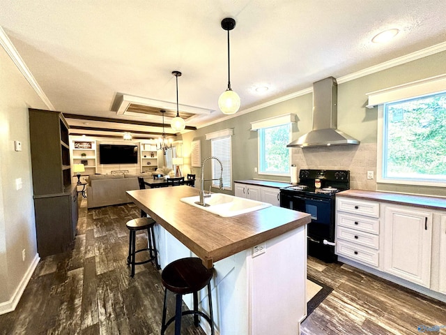 kitchen featuring wall chimney exhaust hood, dark wood-type flooring, black range with electric cooktop, and a sink