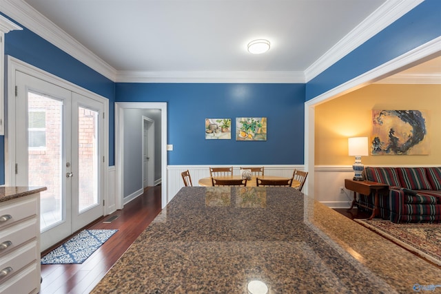 interior space with french doors, crown molding, and dark hardwood / wood-style flooring