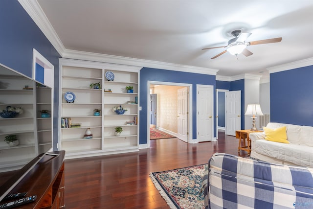 living room featuring built in features, ceiling fan, crown molding, and dark hardwood / wood-style flooring