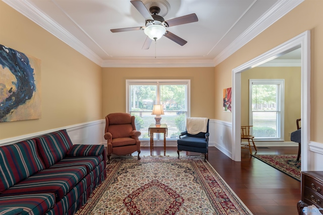 living room featuring ceiling fan, ornamental molding, dark hardwood / wood-style flooring, and a wealth of natural light