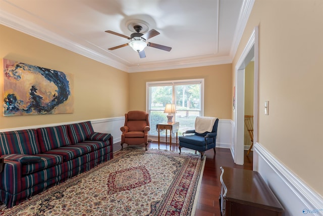 living room featuring crown molding, dark wood-type flooring, and ceiling fan