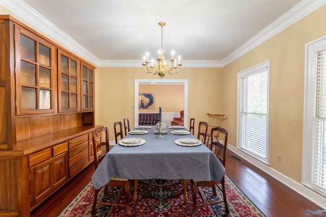 dining space with ornamental molding, dark hardwood / wood-style floors, and an inviting chandelier