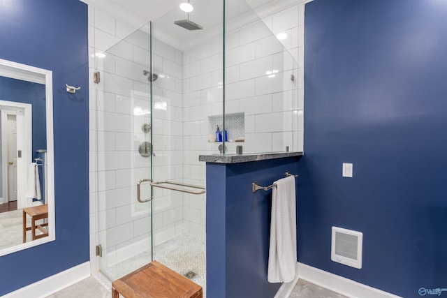 bathroom with ornamental molding and a shower with shower door