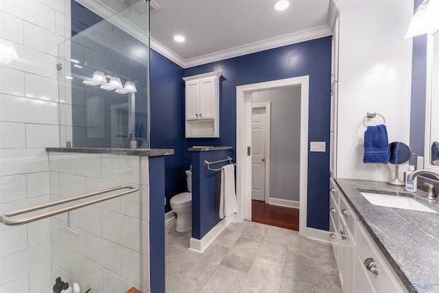 bathroom featuring vanity, crown molding, toilet, and tile patterned floors