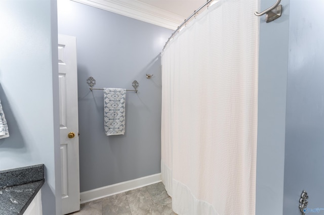 bathroom with walk in shower, vanity, and crown molding