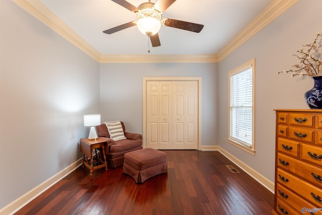 sitting room with crown molding, dark wood-type flooring, and ceiling fan