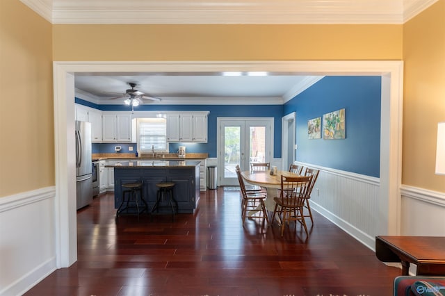 dining room featuring ornamental molding, dark hardwood / wood-style floors, ceiling fan, and french doors