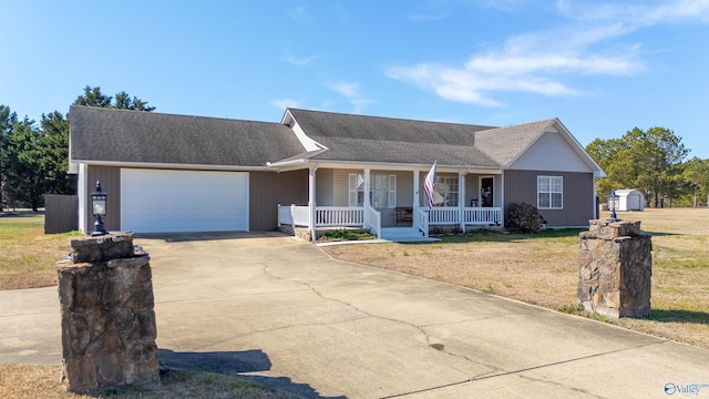 ranch-style house featuring a porch, a garage, and a front yard