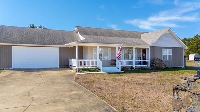 single story home featuring a porch, a garage, and a front yard