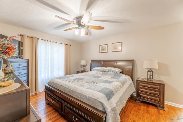 bedroom with dark wood-type flooring and ceiling fan