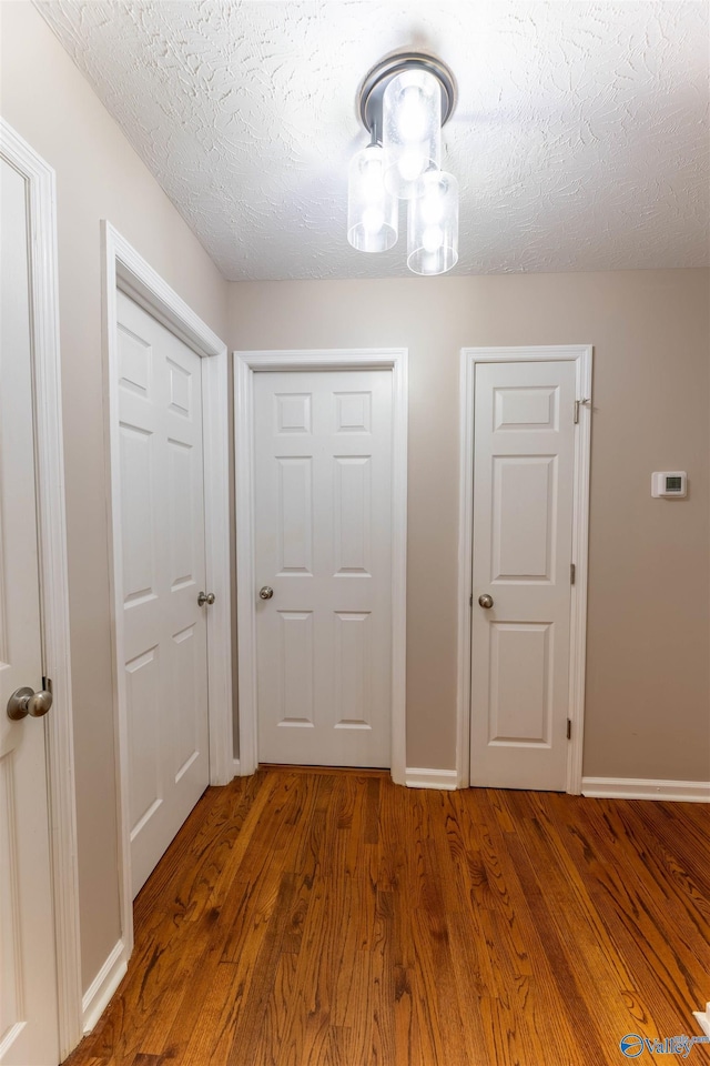 interior space featuring dark hardwood / wood-style floors and a textured ceiling