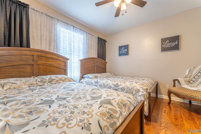 bedroom with ceiling fan, wood-type flooring, and vaulted ceiling