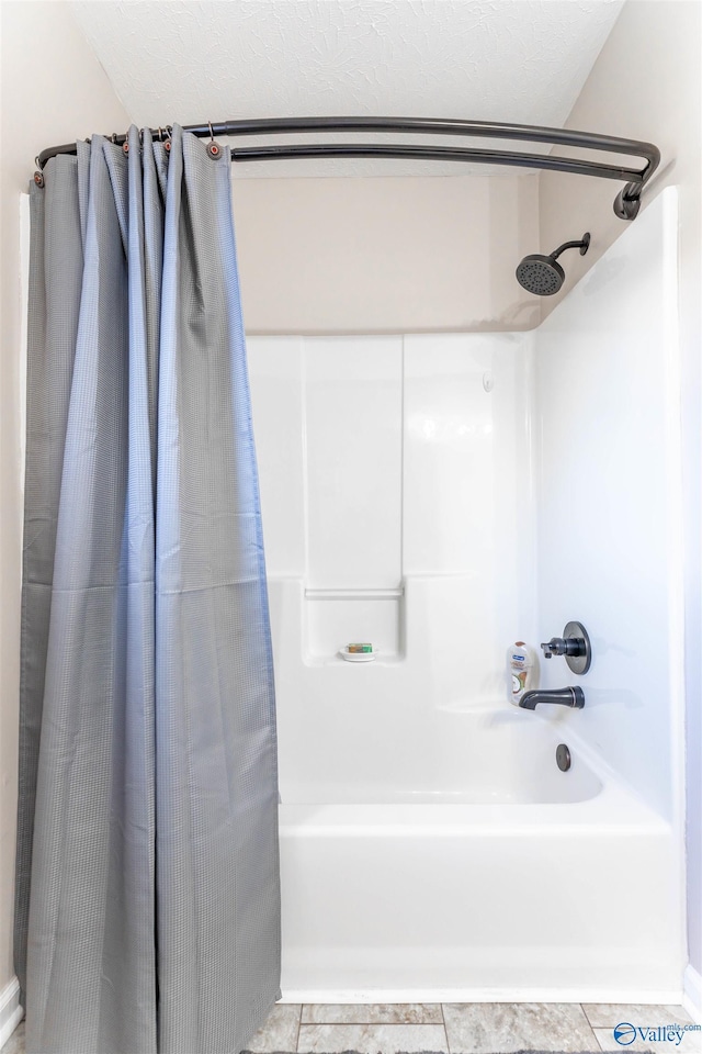 bathroom with shower / bath combination with curtain and tile patterned floors