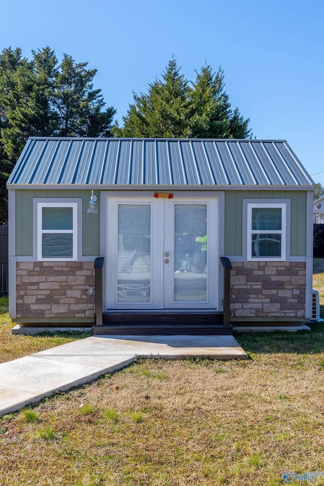 view of front of home with french doors and a front lawn