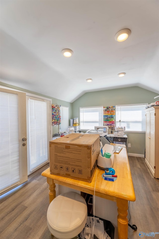 kitchen featuring butcher block countertops, hardwood / wood-style flooring, and vaulted ceiling