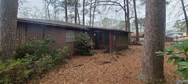 view of side of property with a sunroom