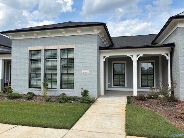 entrance to property with a lawn