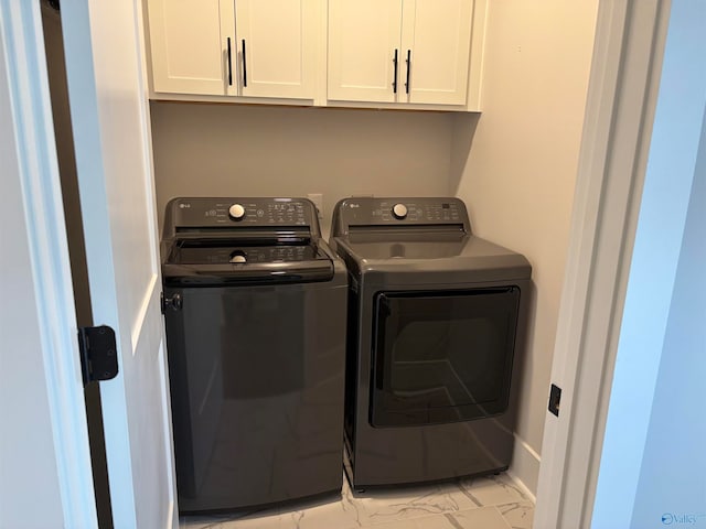 laundry area featuring cabinets and washing machine and clothes dryer