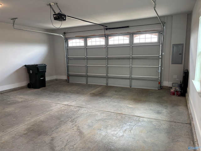 garage with a garage door opener and electric panel