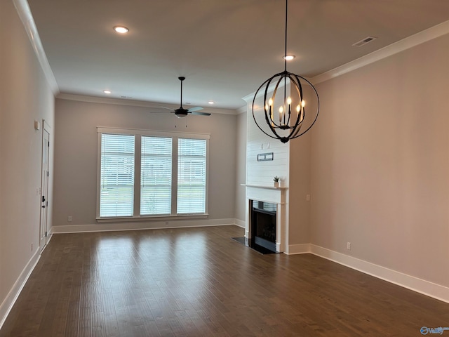 unfurnished living room with ceiling fan with notable chandelier, ornamental molding, and dark hardwood / wood-style flooring