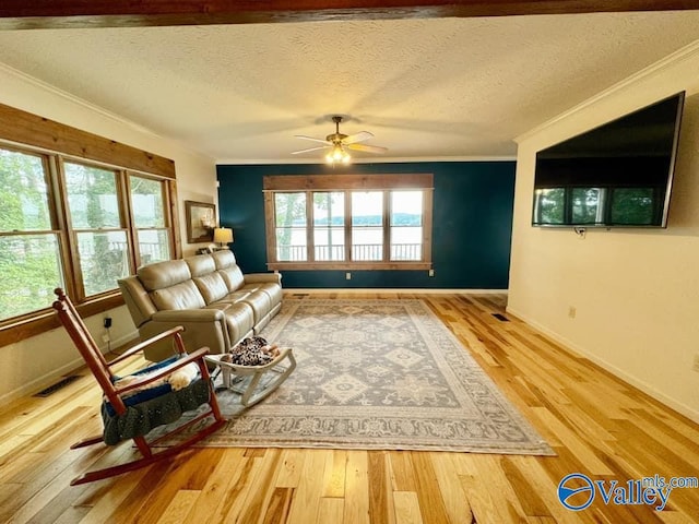 620 County Road 40, Centre, AL 35960 - unfurnished living room featuring ornamental molding, a textured ceiling, baseboards, and wood finished floors