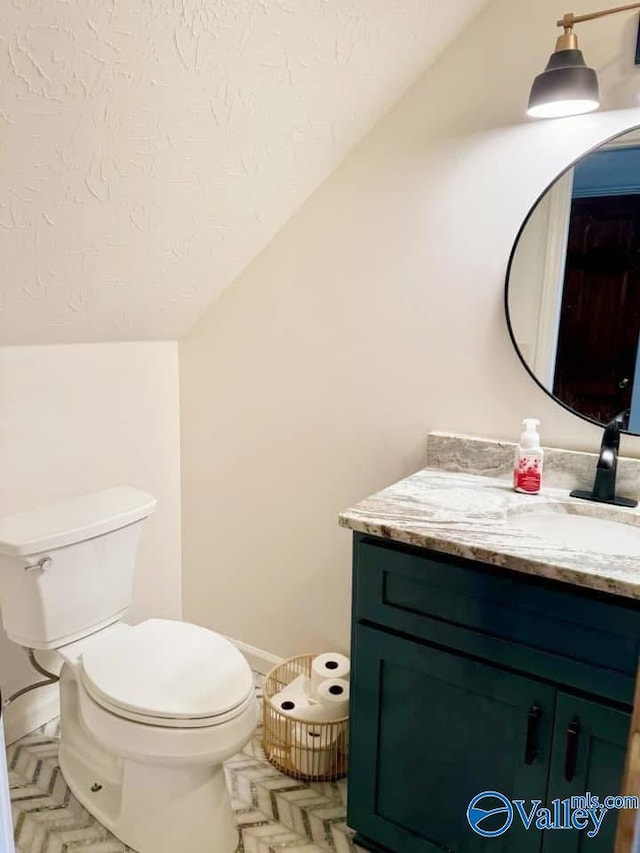 620 County Road 40, Centre, AL 35960 - half bathroom featuring toilet, vaulted ceiling, a textured ceiling, and vanity