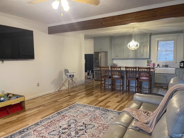 620 County Road 40, Centre, AL 35960 - living room with ceiling fan with notable chandelier, baseboards, light wood-style floors, ornamental molding, and beam ceiling