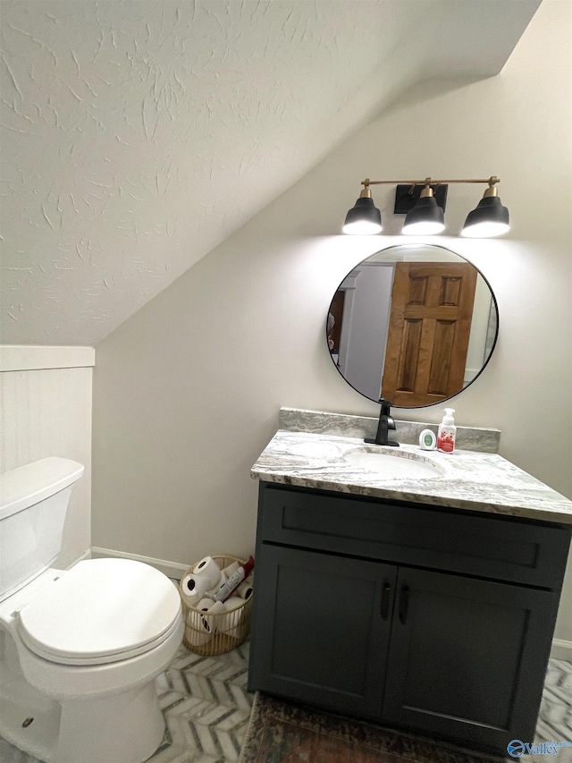620 County Road 40, Centre, AL 35960 - bathroom with lofted ceiling, toilet, a textured ceiling, and vanity