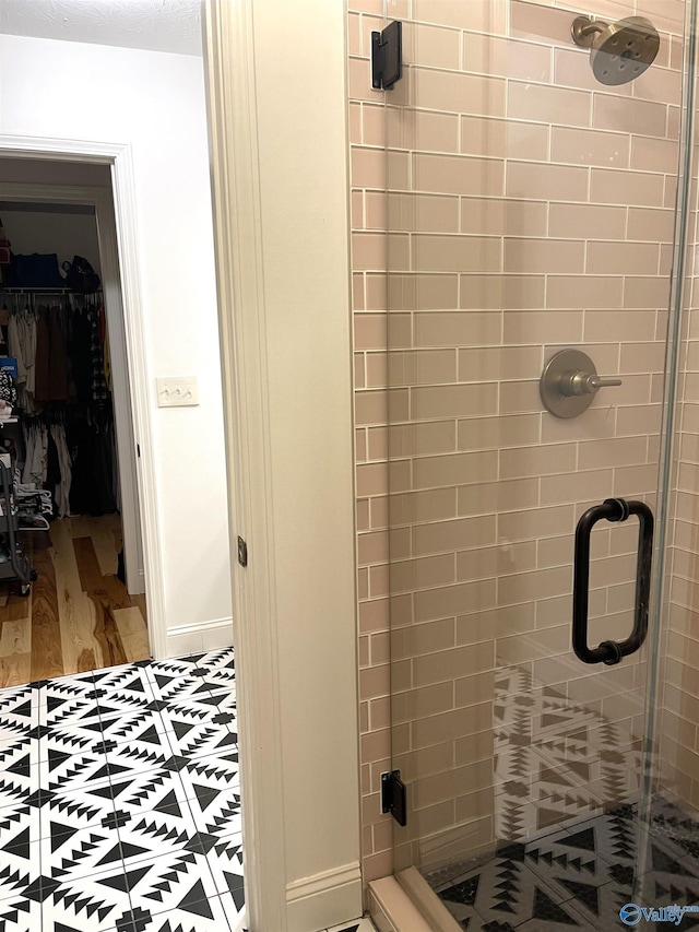 620 County Road 40, Centre, AL 35960 - full bathroom featuring a spacious closet, a shower stall, and baseboards