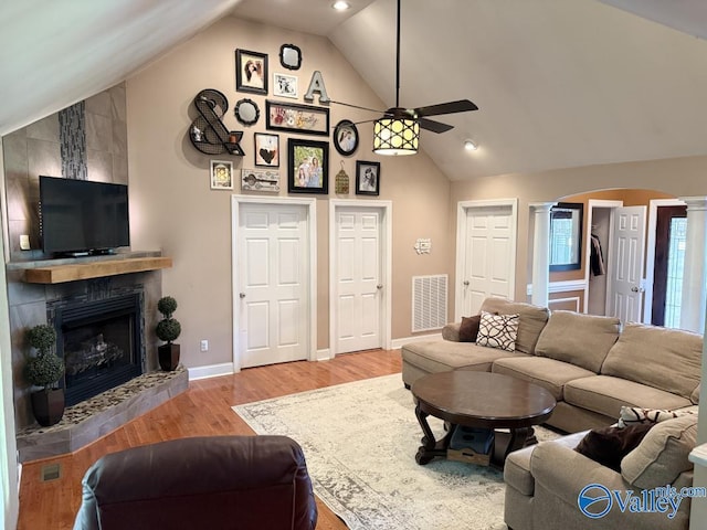 2451 Cedar Ridge Cir, Hokes Bluff, AL 35903 - living area with ornate columns, a ceiling fan, a fireplace, wood finished floors, and high vaulted ceiling