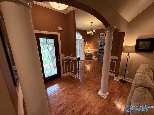 2451 Cedar Ridge Cir, Hokes Bluff, AL 35903 - entryway with ornate columns, crown molding, arched walkways, and dark wood-style floors