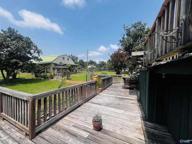 wooden deck featuring a gazebo and a yard
