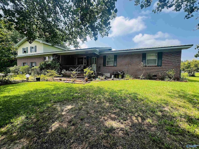 single story home featuring brick siding and a front lawn