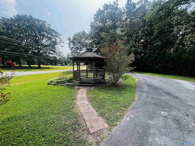 surrounding community with a gazebo and a yard